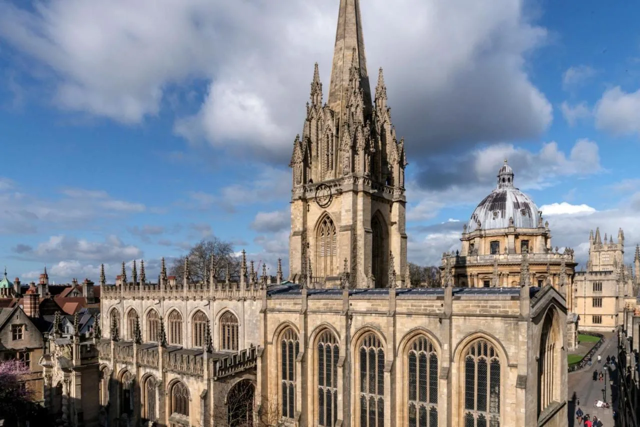 a large building with a clock tower and a cathedral at Old Bank Hotel in Oxford